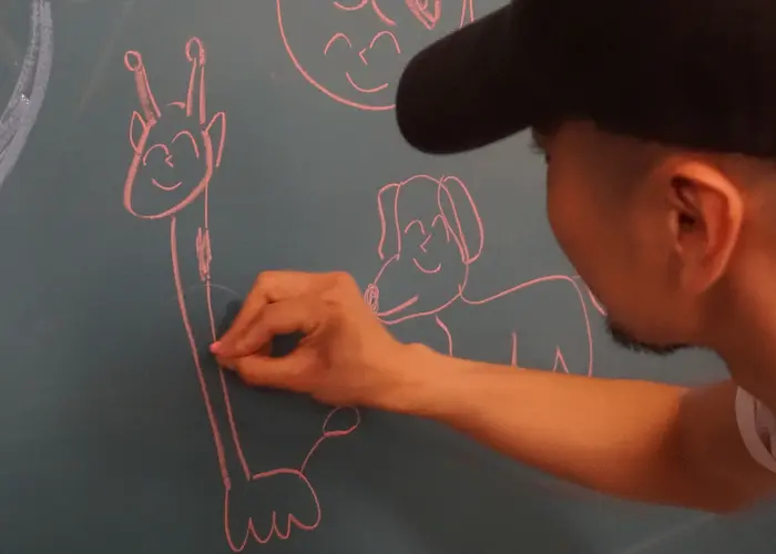 Me drawing a giraffe on a blackboard